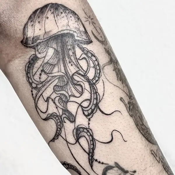 Black and gray Medusa tattoo with marine-style elements and intricate artistic details.