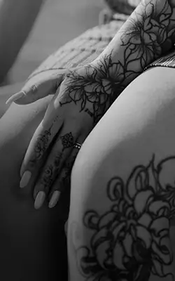 Temporary body designs and mini tattoos applied to fingers.