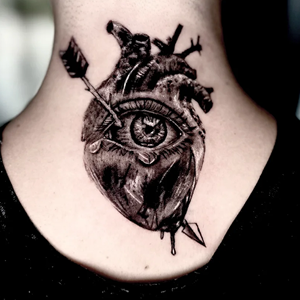 Blackwork realism tattoo on the back of a neck featuring an anatomical heart with a large central eye, pierced by an arrow.