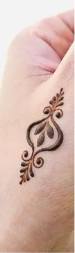 Minimalist geometric henna tattoo design on the back of the hand for temporary body art lovers.